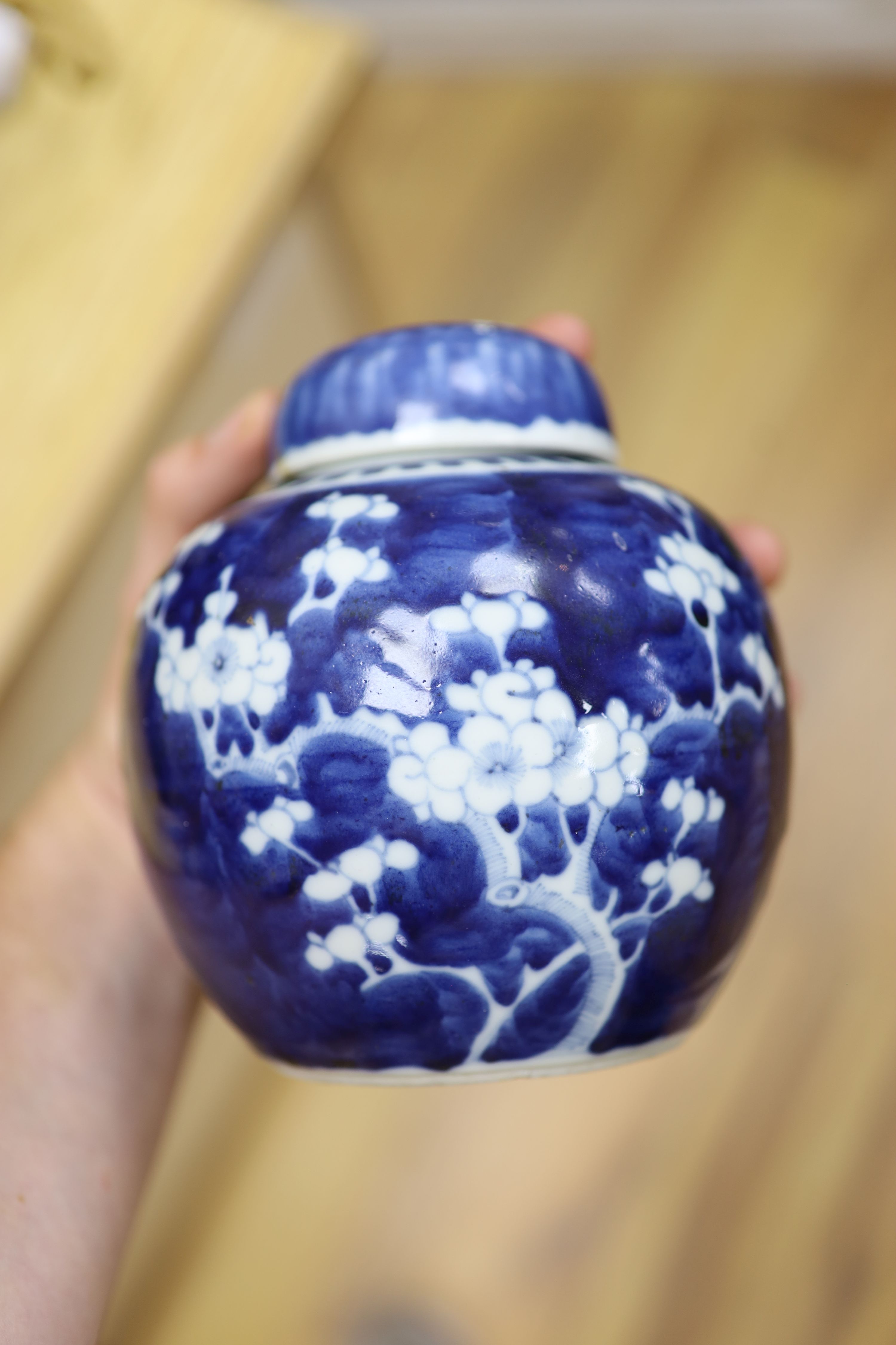 Two Chinese blue and white prunus pattern ginger jars and a similar cylinder vase, tallest 26cm